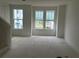 Bright living room with large windows offering natural light and views of the neighborhood at 15089 Grove Lake Dr, Winter Garden, FL 34787