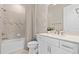 Modern bathroom with a sleek vanity, bathtub, and tiled shower at 1524 Groveline Rd, St Cloud, FL 34771