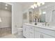 Elegant bathroom features double sinks, white cabinetry, and a separate toilet room at 1524 Groveline Rd, St Cloud, FL 34771