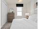 Bright bedroom featuring a stylish dresser, decorative mirror, and soft, neutral tones at 1524 Groveline Rd, St Cloud, FL 34771