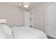 Cozy bedroom with plush white bedding, an ornate chandelier, and neutral wall color at 1524 Groveline Rd, St Cloud, FL 34771