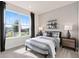 Well-lit bedroom with a large window, nightstands, and decorated shelves at 1524 Groveline Rd, St Cloud, FL 34771