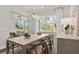 Dining room features an elegant light fixture, view of outdoor living, and neutral decor at 1524 Groveline Rd, St Cloud, FL 34771