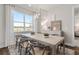 Bright dining room features a modern chandelier and a large window with a view at 1524 Groveline Rd, St Cloud, FL 34771