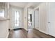 Welcoming foyer with hardwood floors, stylish door, and view into bedroom at 1524 Groveline Rd, St Cloud, FL 34771