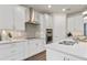 Modern kitchen featuring stainless steel appliances, quartz countertops, and mosaic backsplash at 1524 Groveline Rd, St Cloud, FL 34771