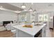 Open-concept kitchen and living area with a large island and modern finishes at 1524 Groveline Rd, St Cloud, FL 34771