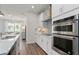 Gourmet kitchen boasts stainless steel appliances, a cooktop, and mosaic backsplash at 1524 Groveline Rd, St Cloud, FL 34771