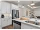 Bright kitchen features stainless steel appliances, white cabinetry, and sleek countertops at 1524 Groveline Rd, St Cloud, FL 34771