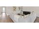 Open concept living room with modern furnishings and hardwood floors at 1524 Groveline Rd, St Cloud, FL 34771