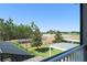 Serene backyard view from the balcony, showcasing lush greenery and manicured landscaping at 15420 Southern Martin St, Winter Garden, FL 34787