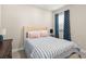 Comfortable bedroom featuring a queen-sized bed, stylish curtains, and modern decor at 15420 Southern Martin St, Winter Garden, FL 34787