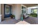 Inviting front porch featuring comfortable seating, plants, decorative pillows, and brick flooring at 15420 Southern Martin St, Winter Garden, FL 34787