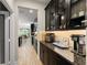 Open kitchen layout with a view to dining, featuring dark cabinets and granite countertops at 15420 Southern Martin St, Winter Garden, FL 34787