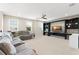 Spacious living room featuring comfortable seating, a ceiling fan, and a custom entertainment center at 15420 Southern Martin St, Winter Garden, FL 34787