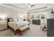 Spacious main bedroom with tray ceiling, large windows, king bed, and sitting area at 15420 Southern Martin St, Winter Garden, FL 34787