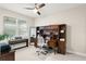 Bright office space with large desk, hutch, piano, and a view to the front yard at 15420 Southern Martin St, Winter Garden, FL 34787