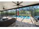 Gorgeous screened-in pool area with a hot tub, ample seating, and outdoor grill at 15420 Southern Martin St, Winter Garden, FL 34787