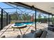 Inviting screened-in pool area with hot tub, poolside seating, and lush landscaping at 15420 Southern Martin St, Winter Garden, FL 34787