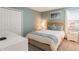 Cozy bedroom features queen-size bed with closet, and nightstand with lamp at 1575 Plunker Dr, Davenport, FL 33896