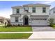 Charming two-story home with manicured lawn and a two-car garage at 1575 Plunker Dr, Davenport, FL 33896
