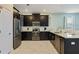 Modern kitchen featuring stainless steel appliances and dark wood cabinetry at 1575 Plunker Dr, Davenport, FL 33896