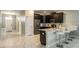 Modern kitchen featuring stainless steel appliances, dark wood cabinetry and breakfast bar at 1575 Plunker Dr, Davenport, FL 33896