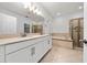 Spacious bathroom featuring double sinks, walk-in shower, soaking tub, and tile flooring at 15862 Citrus Grove Loop, Winter Garden, FL 34787