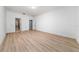 A bedroom featuring wood floors, neutral walls, and doors to the bathroom and closet at 15862 Citrus Grove Loop, Winter Garden, FL 34787