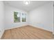 Bright, empty bedroom features wood-look flooring and natural light from the double window at 15862 Citrus Grove Loop, Winter Garden, FL 34787