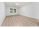 A bedroom featuring wood floors, neutral walls, large windows, and recessed lighting at 15862 Citrus Grove Loop, Winter Garden, FL 34787