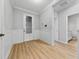 Inviting foyer with decorative front door, stylish wainscoting and wood-look flooring at 15862 Citrus Grove Loop, Winter Garden, FL 34787