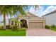 Charming single-story home with a well-manicured lawn and a welcoming arched entryway leading to the front door at 15862 Citrus Grove Loop, Winter Garden, FL 34787