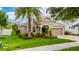 Beautiful single-story home featuring mature trees, lush landscaping, and a paver driveway at 15862 Citrus Grove Loop, Winter Garden, FL 34787