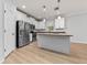 Kitchen with granite countertops, stainless steel appliances, and wood-look floors at 15862 Citrus Grove Loop, Winter Garden, FL 34787
