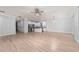 Open concept living area with views of the kitchen, stainless appliances, and wood-look floors at 15862 Citrus Grove Loop, Winter Garden, FL 34787