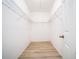 Walk-in closet with shelving and wood floors at 15862 Citrus Grove Loop, Winter Garden, FL 34787