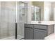 Modern bathroom with walk-in shower featuring gray vanity with white countertop and decorative wall tile at 16103 Silver Brook Way, Winter Garden, FL 34787