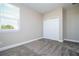 Comfortable bedroom with natural light from the window and convenient closet, offering a relaxing space at 16103 Silver Brook Way, Winter Garden, FL 34787