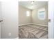 Sunlit bedroom with plush carpet, two windows, and a neutral color scheme creates a relaxing retreat at 16103 Silver Brook Way, Winter Garden, FL 34787