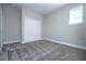 Bright bedroom with plush carpeting, a window for natural light, and a closet for storage convenience at 16103 Silver Brook Way, Winter Garden, FL 34787