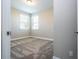 Sunlit bedroom with plush carpet, two windows, and a neutral color scheme creates a relaxing retreat at 16103 Silver Brook Way, Winter Garden, FL 34787