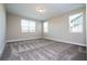 Spacious bedroom featuring plush carpeting and multiple windows providing ample natural light at 16103 Silver Brook Way, Winter Garden, FL 34787