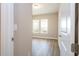 Bedroom features wood-look floors and abundant natural light from two windows overlooking the yard at 16103 Silver Brook Way, Winter Garden, FL 34787