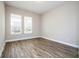 Empty bedroom featuring wood-look floors and plenty of natural light from the double windows at 16103 Silver Brook Way, Winter Garden, FL 34787