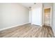 Bedroom with wood-look floors and closet, leading to an ensuite bathroom with shower and tub at 16103 Silver Brook Way, Winter Garden, FL 34787
