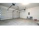 Spacious two car garage with concrete floors, overhead lighting, and two automatic garage doors at 16103 Silver Brook Way, Winter Garden, FL 34787
