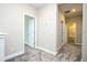 Upstairs hallway with carpeted floor and view into bathroom at 16103 Silver Brook Way, Winter Garden, FL 34787