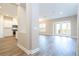 Open-concept living area with kitchen, dining and access to patio through glass doors at 16103 Silver Brook Way, Winter Garden, FL 34787