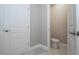 Compact toilet room with tile floors, toilet, and white doors at 16103 Silver Brook Way, Winter Garden, FL 34787